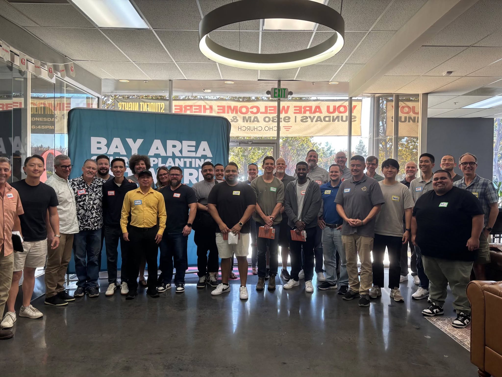 A group gathered with the Bay Area Church Planting Network banner