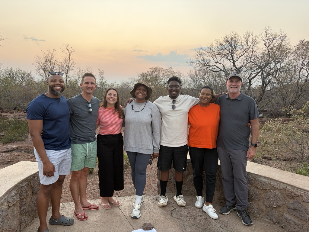 Seven people gathered outdoors during the South Africa visit